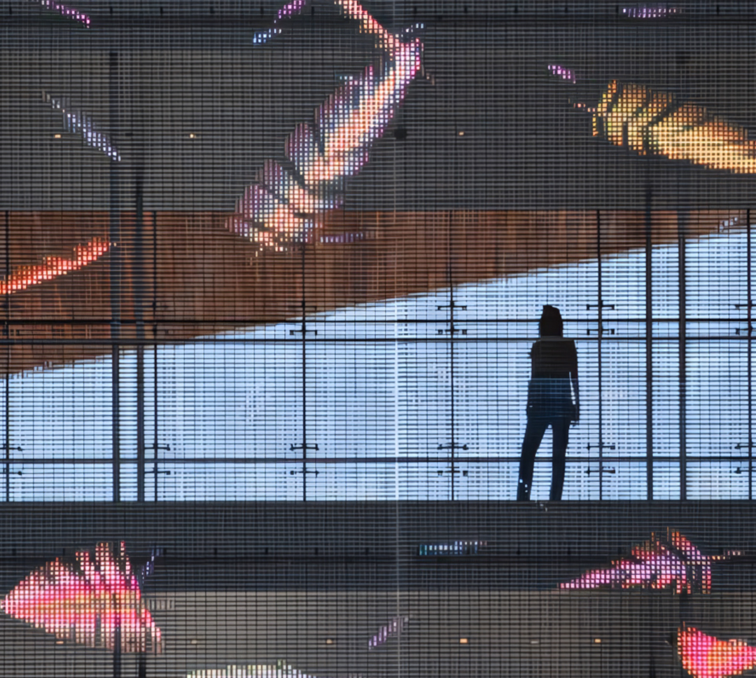 Transparent LED mesh display used on retail window allowing natural light while delivering high brightness digital content