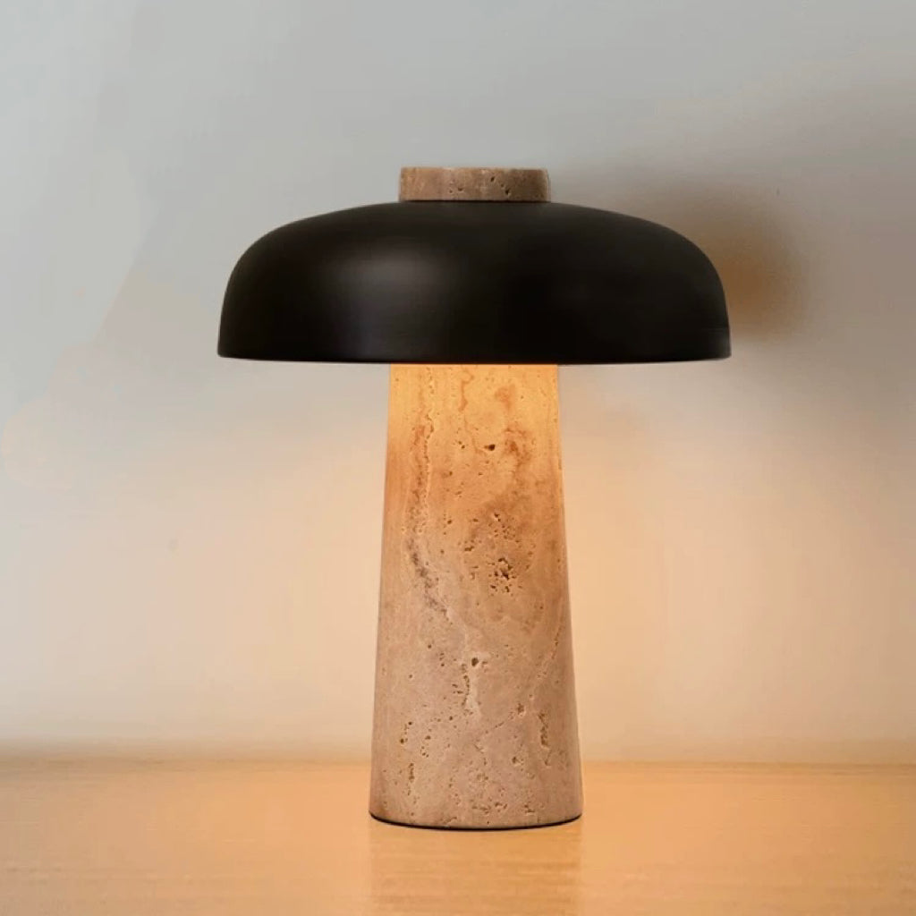 Travertine stone table lamp with black metal shade and warm ambient glow, ideal for bedside tables and modern interiors.
