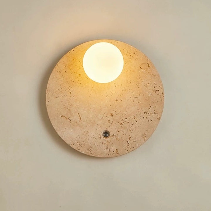 travertineglow 250 round travertine stone wall lamp with soft glowing LED diffuser providing warm ambient wall lighting