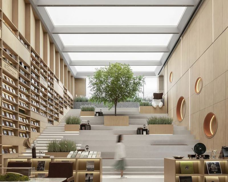 LED stretch ceiling panels illuminating a modern cultural library space with tiered seating, natural light effect and contemporary architectural design.