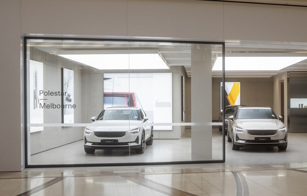 Ultra Panel Lighting LED stretch ceiling panels illuminating a modern car showroom with seamless bright ceiling design and clean architectural lighting.