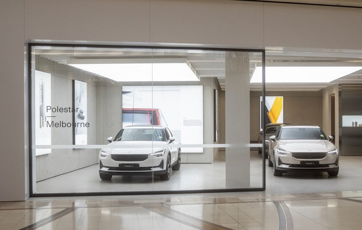 Ultra Panel Lighting LED stretch ceiling panels illuminating a modern car showroom with seamless bright ceiling design and clean architectural lighting.