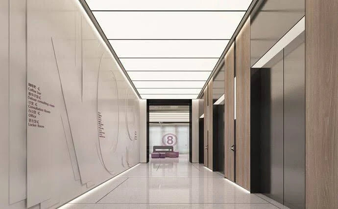 LED stretch ceiling panels illuminating a modern office lobby corridor with seamless uniform lighting and contemporary architectural finishes.