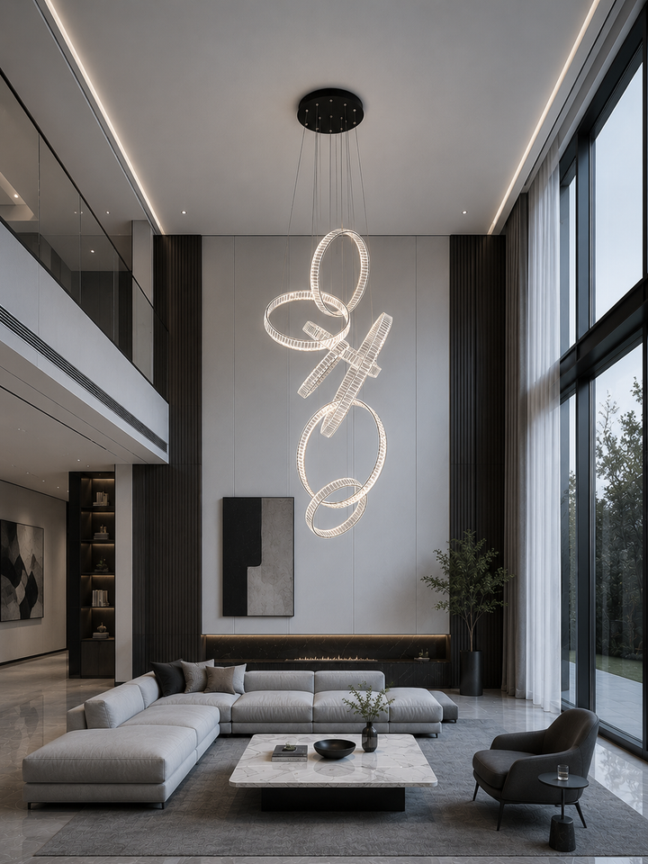 Vertical cascading crystal ring chandelier in a modern double-height living room with linear fireplace, dark timber panels and floor-to-ceiling glazing, Pharaoh Vertical Custom Crystal Chandelier by Lucretia