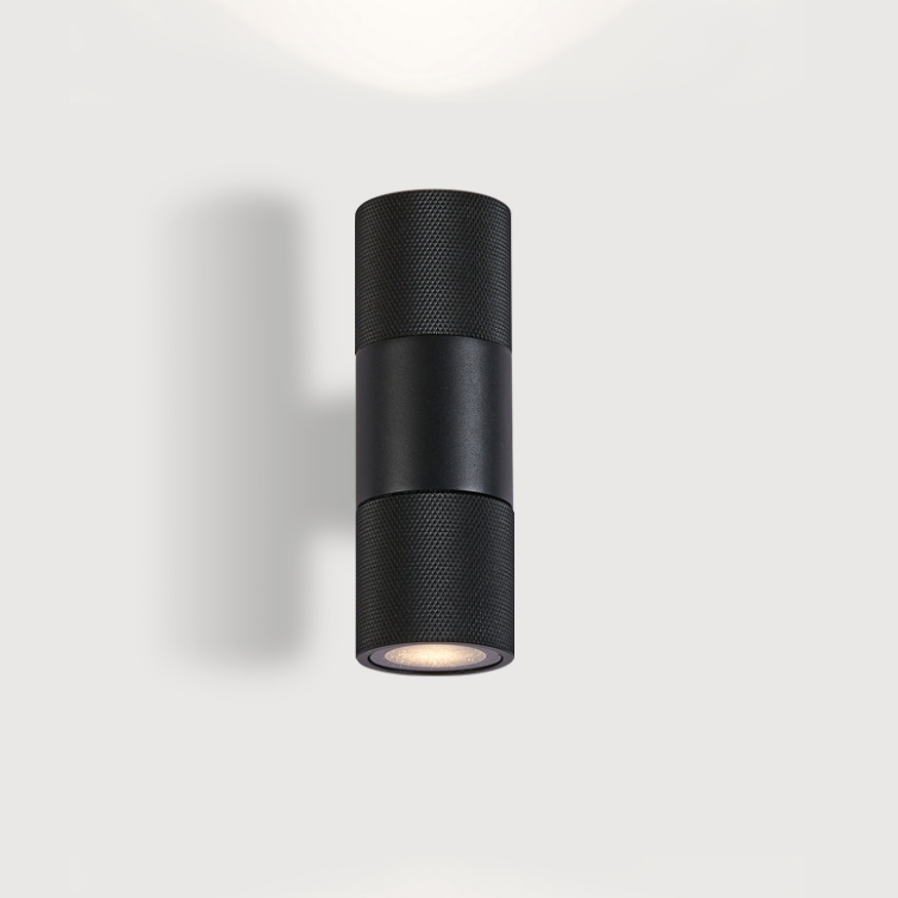 Black architectural up and down wall light with soft diffused illumination.