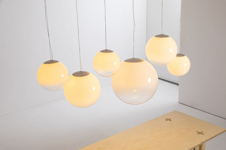 Warm white glass pendant light installation for kitchen island and dining spaces