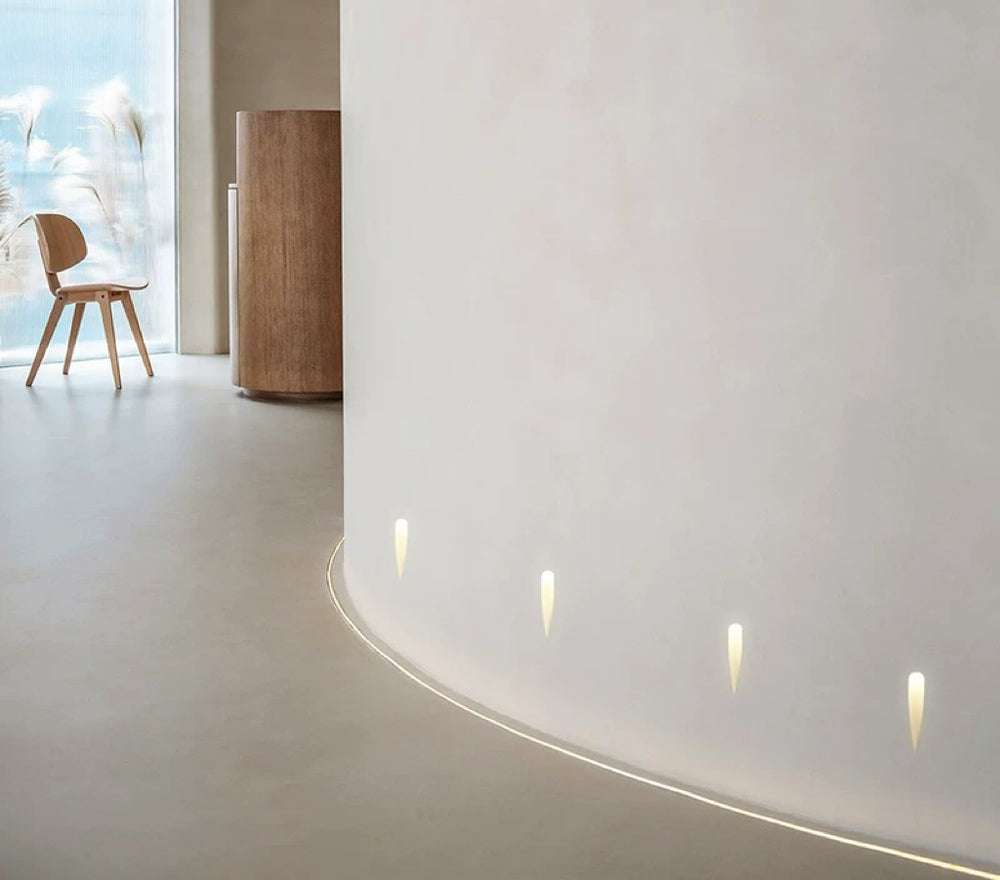 water gypsum wall lights installed along a curved hallway wall delivering soft indirect LED wall lighting