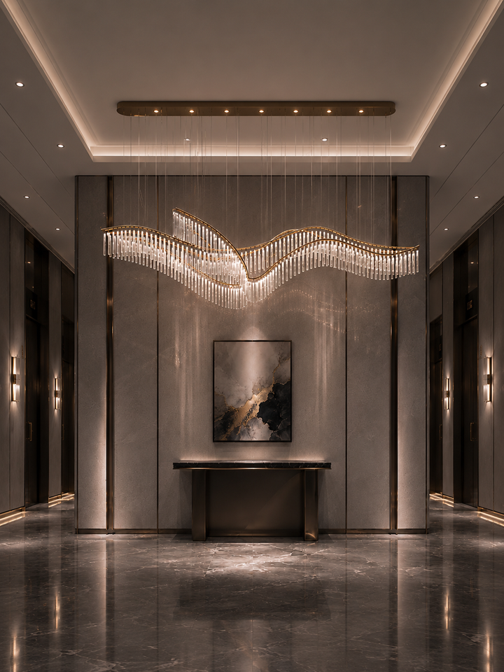 Wave-form hand-blown glass linear pendant in a luxury hotel lift lobby corridor with symmetrical wall lights, abstract artwork and grey marble flooring, Eden Custom Linear Pendant by Lucretia