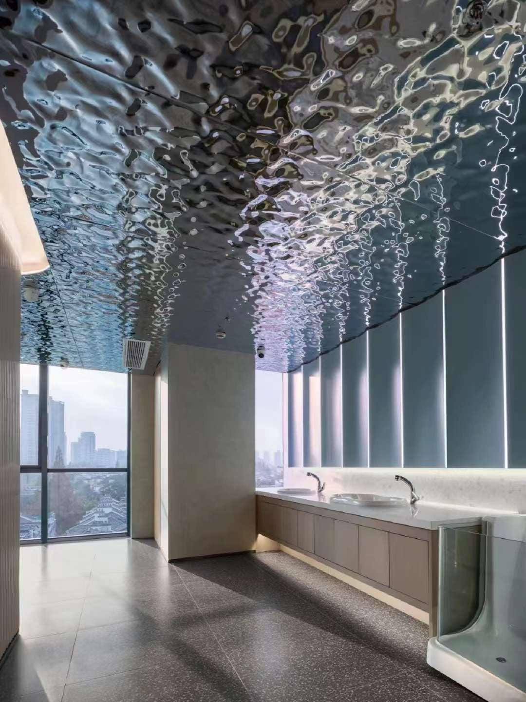 WaveForm 304 stainless steel ceiling panel adding texture and depth to a modern office interior