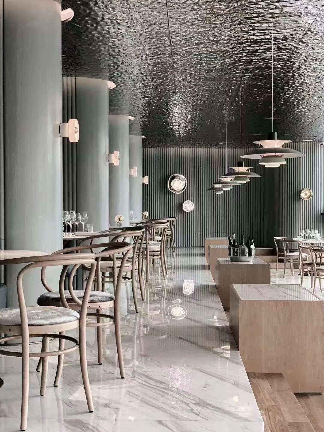 WaveForm 304 stainless steel ceiling panel with wave texture installed in a contemporary restaurant interior