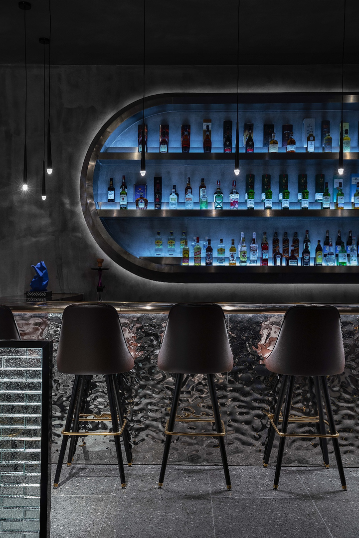 WaveForm 304 stainless steel wall panel used as a dramatic backdrop in a contemporary bar interior