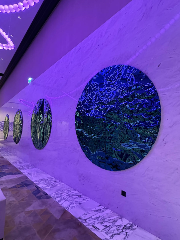 WaveForm 304 stainless steel wall panel with wave pattern enhanced by purple lighting as a feature wall