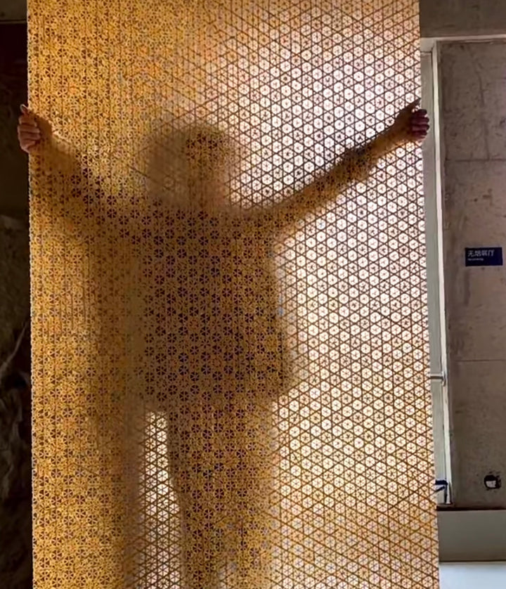 Woven bamboo decorative wall panels showing translucent texture and depth with human silhouette behind