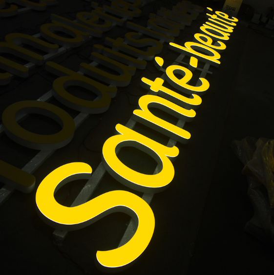 Yellow front lit LED channel letter signage with illuminated acrylic letters for outdoor commercial signage at night