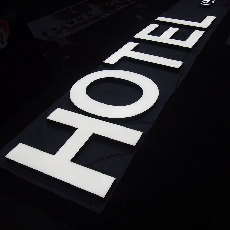 3D LED resin letter sign with illuminated white resin face, designed for hotel and commercial building signage.