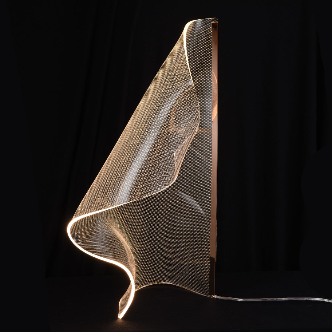 Acrylic feature table lamp Silken B showcasing sculptural curves and warm illumination suitable for bedrooms, console areas and modern homes.