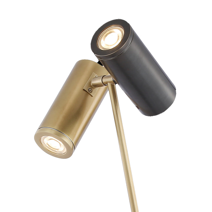 Close-up of adjustable dual-head table lamp showing brass and black finish ideal for reading and task lighting.