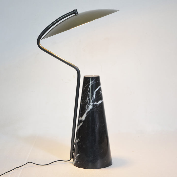 Modern table lamp with black marble base and sculptural angled metal arm, offering warm directed lighting for contemporary Australian homes.