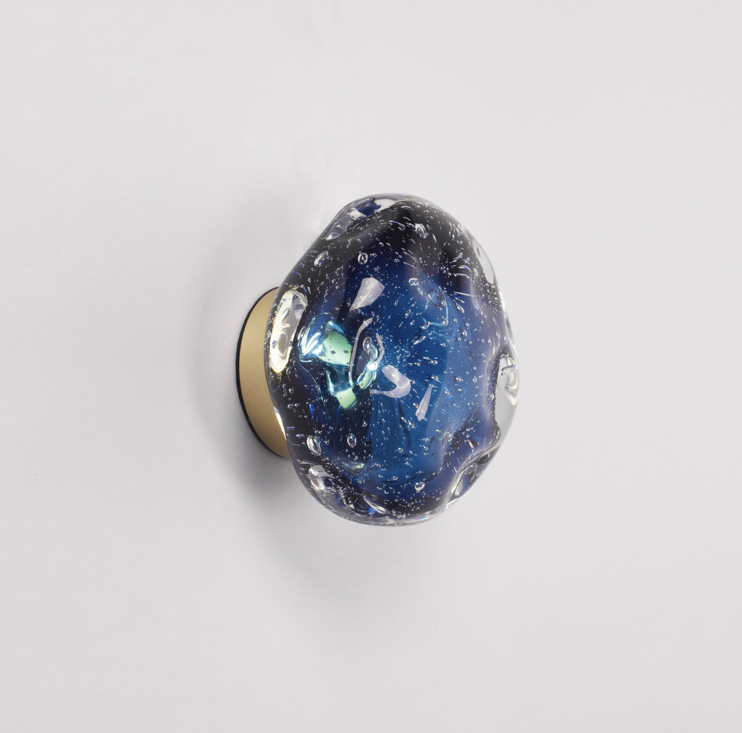 blue galaxy sculptural glass wall lamp providing soft ambient wall lighting with a glowing planet like appearance