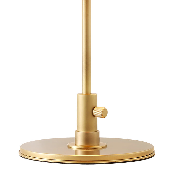 Detail view of brass table lamp base and switch, highlighting refined craftsmanship and modern decorative lighting design.
