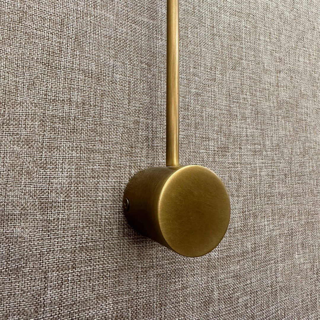 sleek brass wall mounted reading light with led lamp head designed for bedside task and ambient lighting