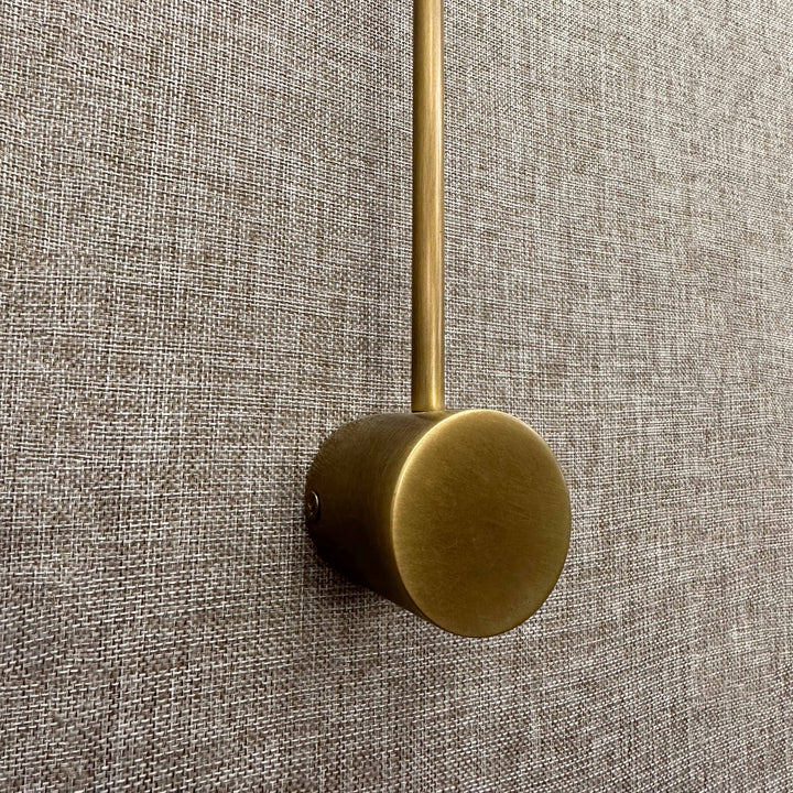 sleek brass wall mounted reading light with led lamp head designed for bedside task and ambient lighting