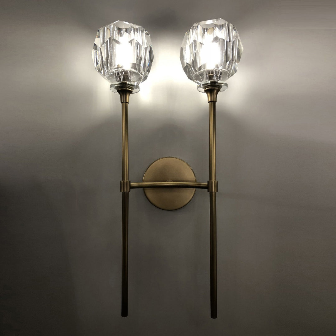 dual head faceted crystal brass wall lamp installed on interior wall creating radiant ambient lighting ideal for living rooms bedrooms hallways and contemporary feature walls