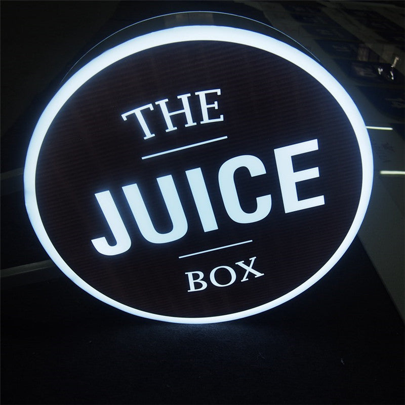 Custom LED light box sign for restaurant branding, featuring illuminated logo and round light box design.