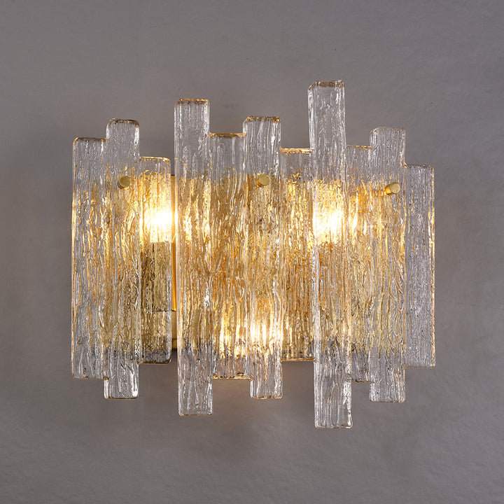 textured glass and brass eve wall lamp providing warm ambient lighting in a contemporary interior