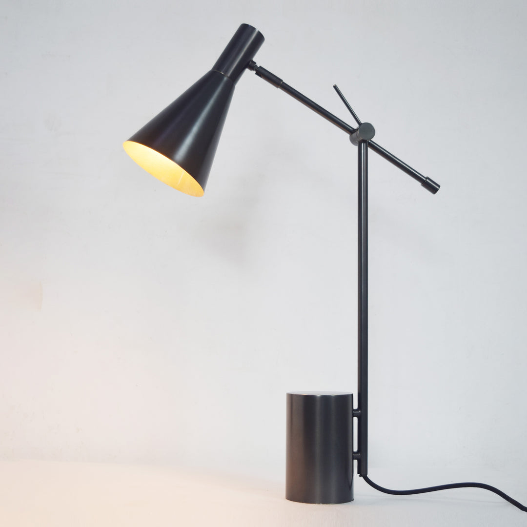 Farrow Table Lamp with adjustable head in black finish providing focused task lighting for desks, bedrooms and workspaces.