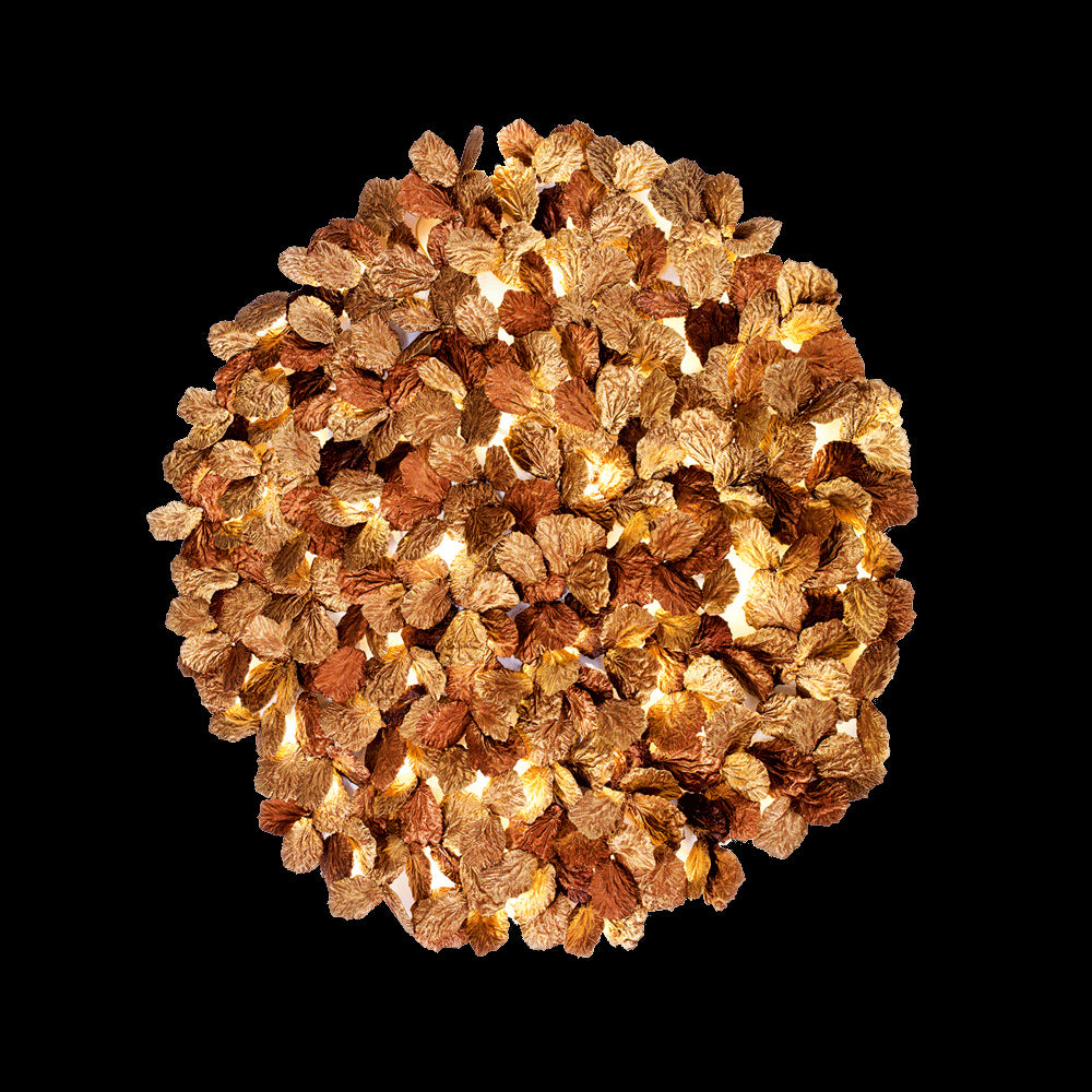 handcrafted gold leaf round wall lamp providing warm ambient lighting in a luxury interior setting