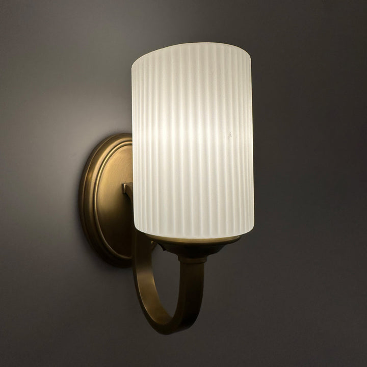 fluted glass brass wall lamp installed on interior wall providing soft diffused indoor wall lighting ideal for bedrooms hallways and contemporary home interiors