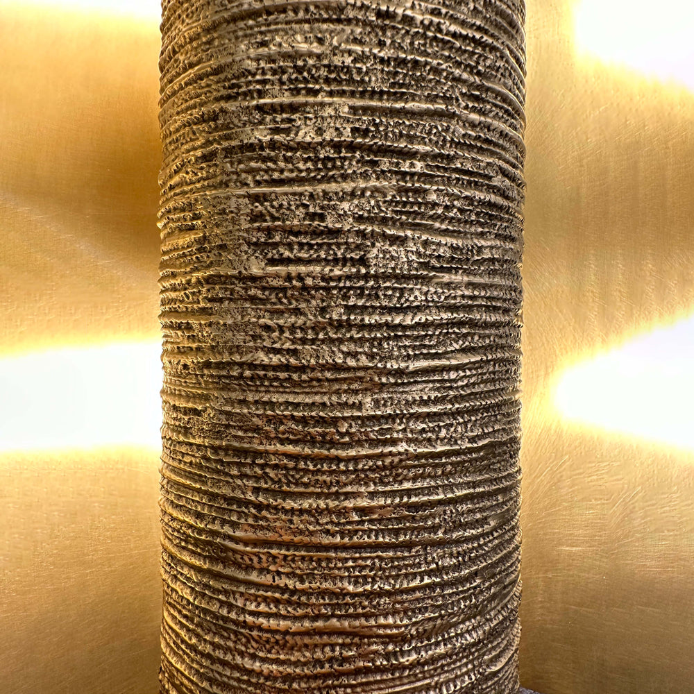 Hedda Wall Lamp close up textured centre detail modern brass designer wall light for interior ambient lighting