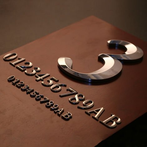 LED illuminated house number sign with modern metal finish, designed for residential address identification.