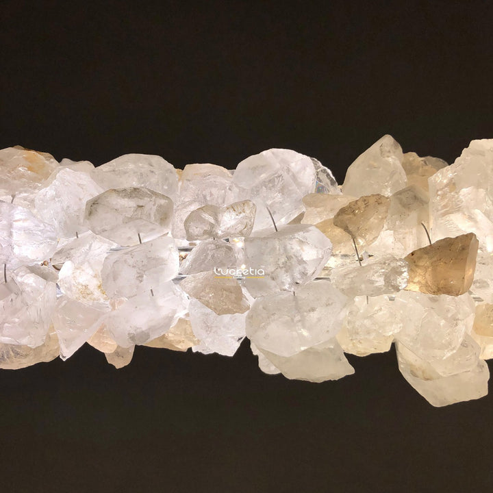 close up of Belo Horizonte crystal linear pendant showing raw mineral crystal texture with softly diffused LED light