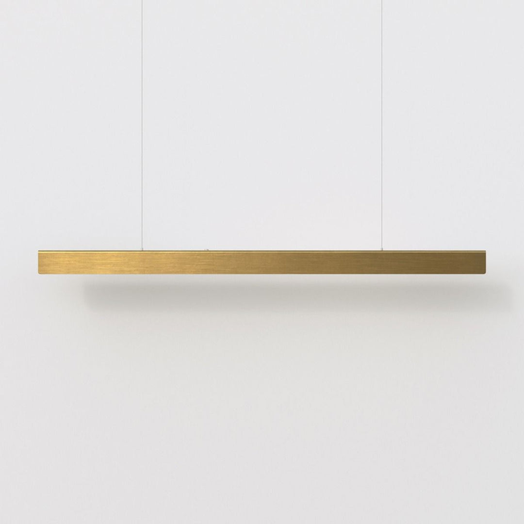 Lucretia Chaumet linear pendant light in brushed brass, featuring a refined minimalist profile ideal for kitchen islands and dining spaces.
