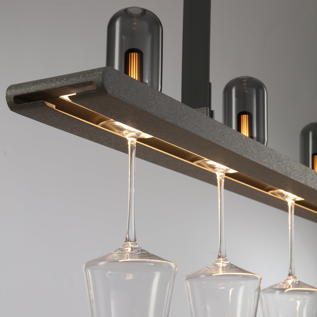 Connaught Bar Linear Pendant Light by Lucretia Lighting illuminating wine glasses with warm designer LED lighting