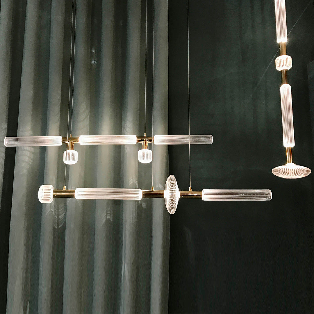 Etoile Horizontal Pendant Light by Lucretia Lighting featuring engraved blown glass and polished metallic accents in a modern interior