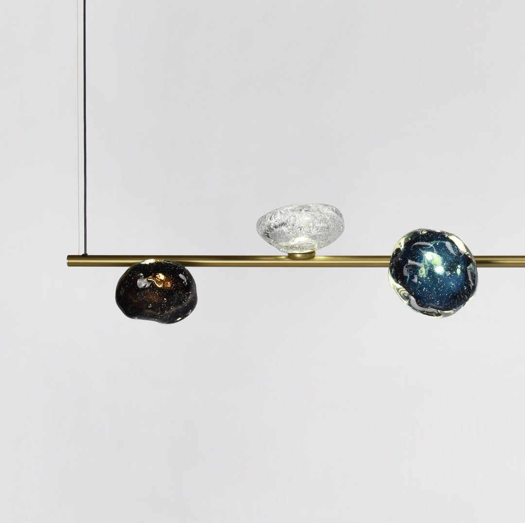 Galaxy Custom Linear Pendant Light by Lucretia Lighting featuring hand-blown glass orbs in cosmic colours on a brushed brass bar