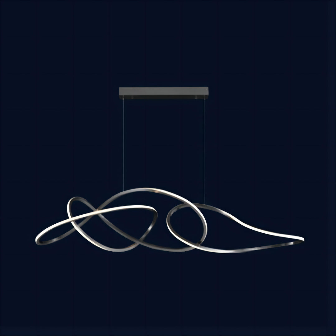 Lucretia Lighting Kyma sculptural designer pendant light with fluid metal curves in a minimalist studio setting