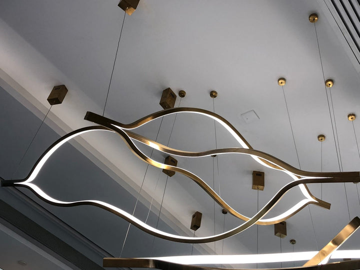 Lacquer 2 Pendant Light installed as a sculptural linear feature with intertwined LED rings by Lucretia Lighting