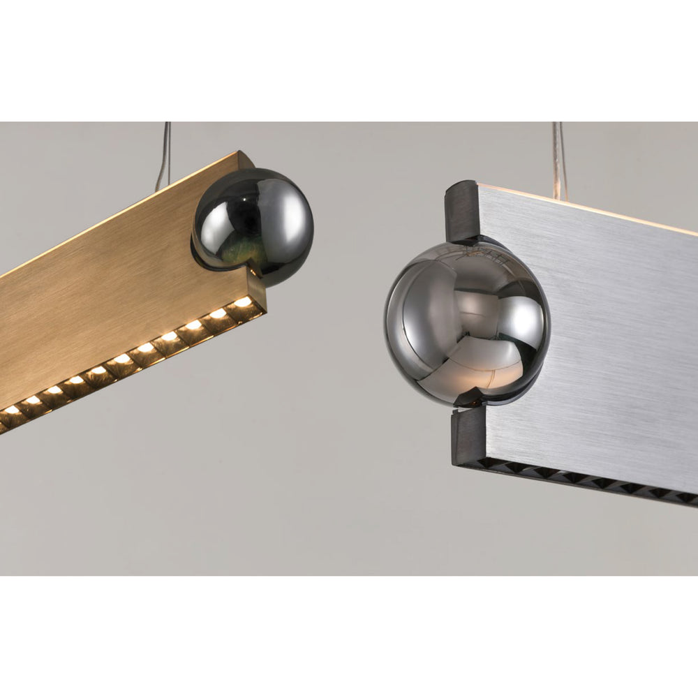 close up of Orbit linear pendant light showing metallic orb touch control and brushed metal LED housing