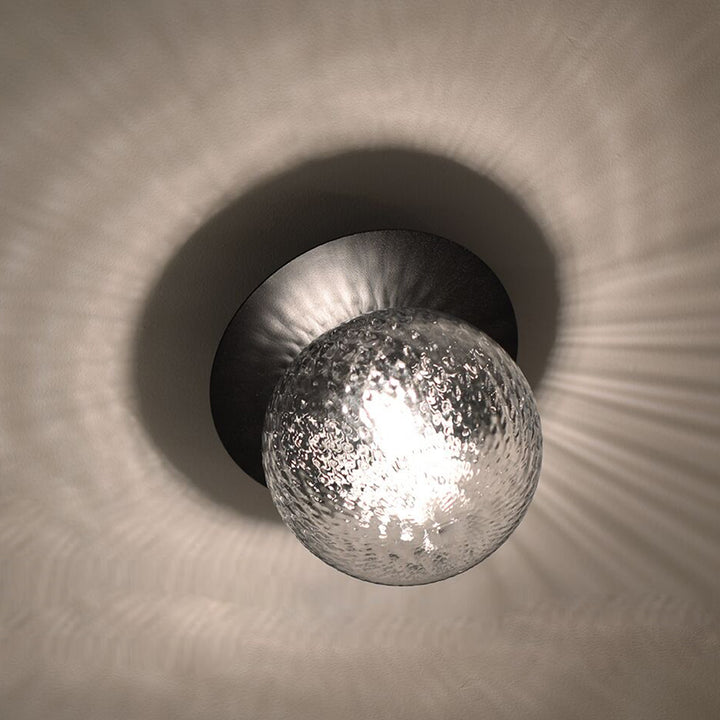rippled glass sphere wall lamp close up showing soft ambient light reflections ideal for hallway wall lighting bathroom wall light and modern interior spaces