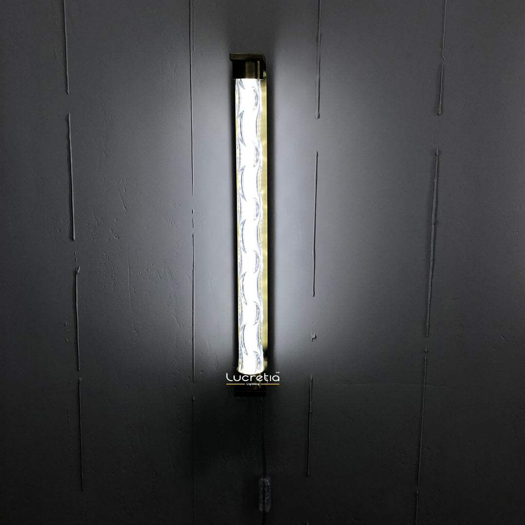 marinot 1 modern LED wall lamp with textured glass diffuser mounted on a dark wall providing ambient interior wall lighting