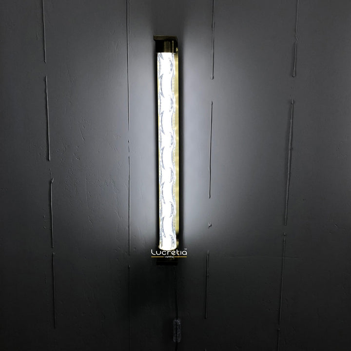 marinot 1 modern LED wall lamp with textured glass diffuser mounted on a dark wall providing ambient interior wall lighting