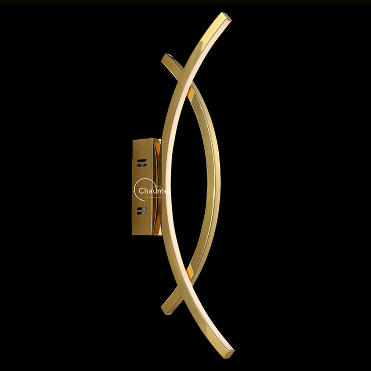 modern curved metallic wall lamp shown in close up on black background ideal for contemporary indoor wall lighting hallway wall light and minimalist home interiors