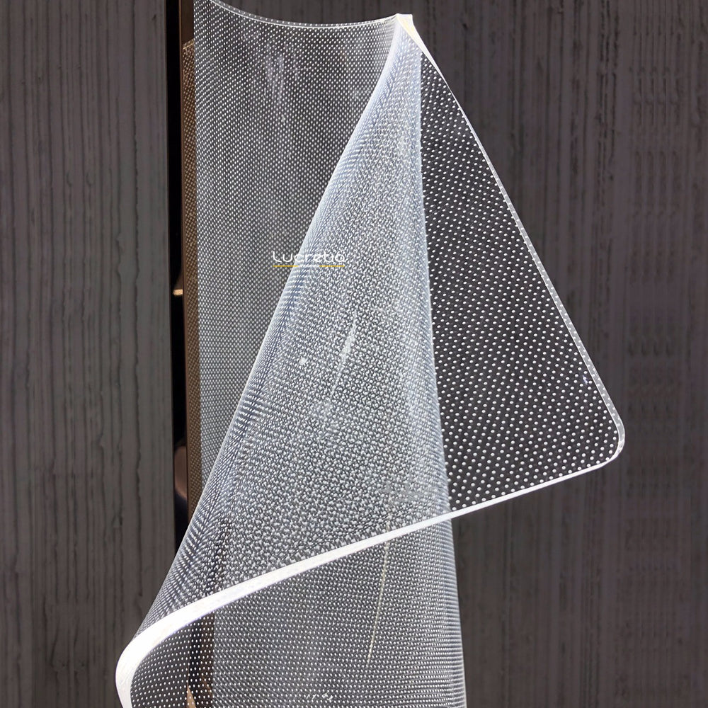 Modern Silken A acrylic table lamp showcasing illuminated flowing contours that reflect and refract light softly for atmospheric interior lighting.