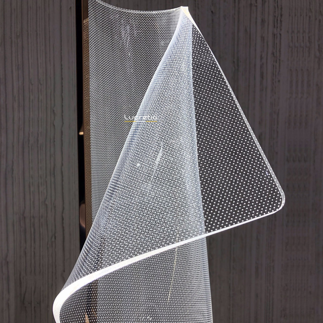 Modern Silken A acrylic table lamp showcasing illuminated flowing contours that reflect and refract light softly for atmospheric interior lighting.