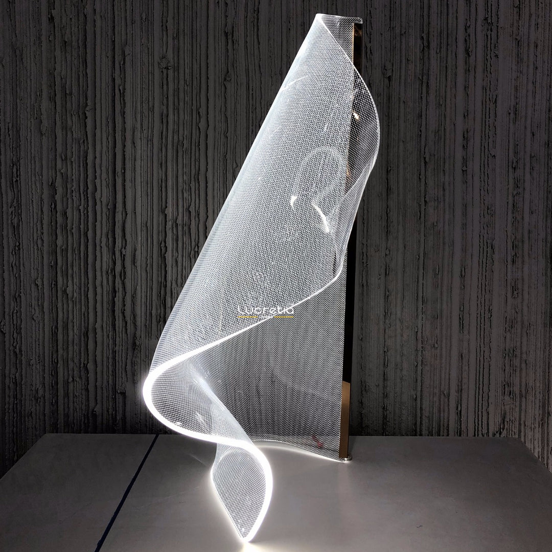 Modern Silken B acrylic table lamp providing soft ambient illumination with fluid contours suited to contemporary interior spaces.