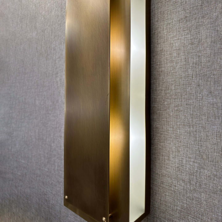 Angle closeup of Regis Wall Lamp brushed brass architectural linear wall light for luxury interiors